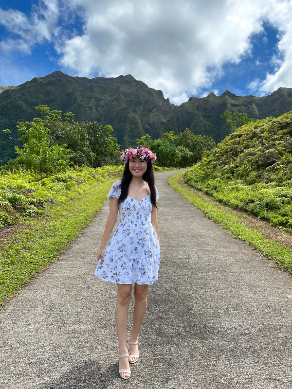 Misa wearing a haku lei with the koʻolau mountains in the background.