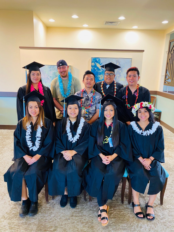 Our classmate took a group photo with our gown.