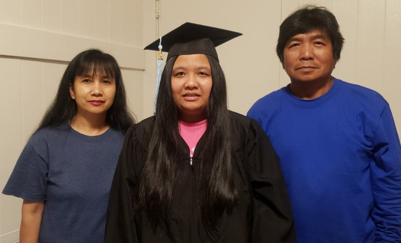 This is a picture of me in my cap and gown with my parents