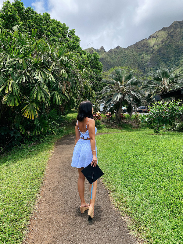 Baby blue dress looking up into the mountains holding cap