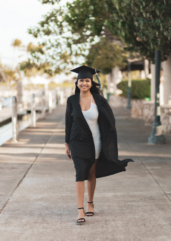 Walking with cap, gown, and tassel on