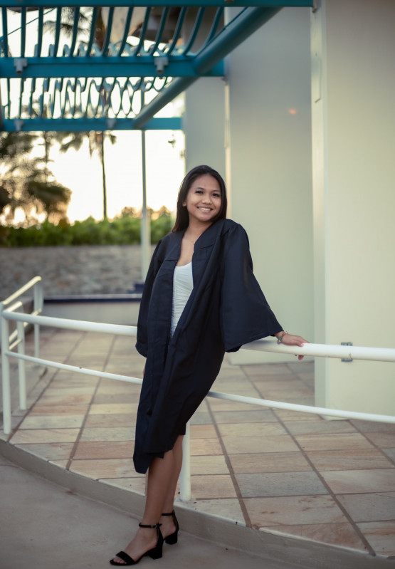 Leaning on a rail with gown