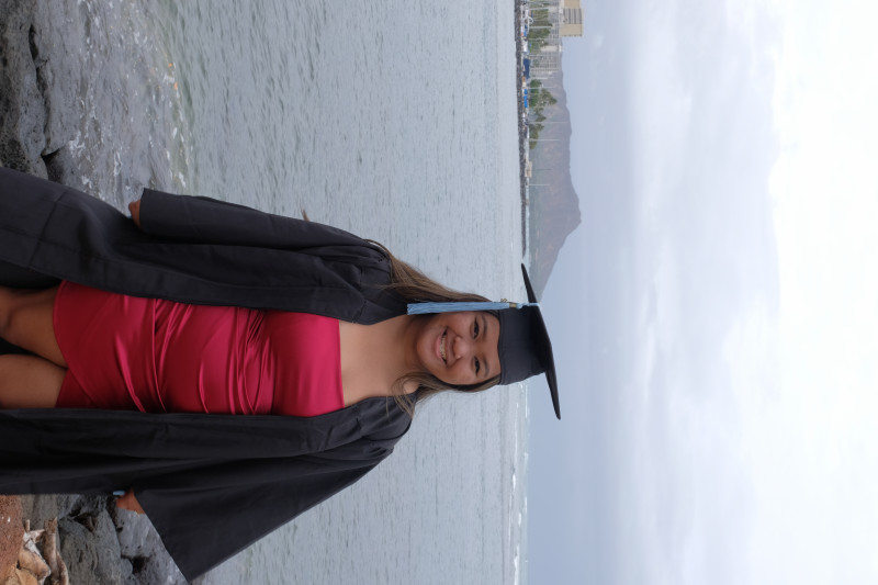 A picture of me in Ala Moana Beach park with my cap and gown.