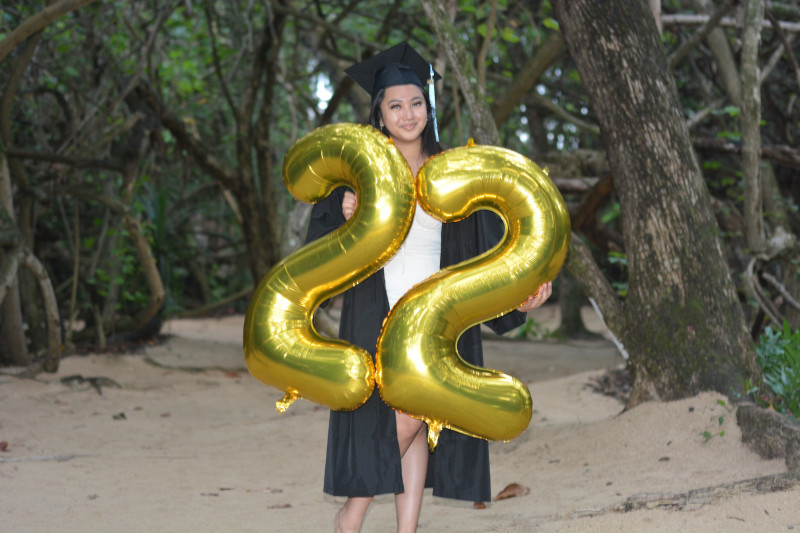 Graduate holding a '22' balloon