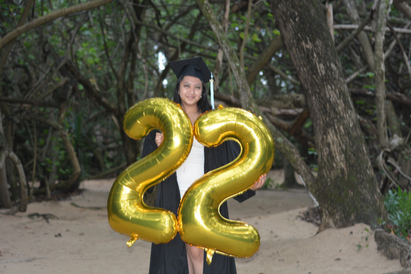 Graduate holding a '22' balloon