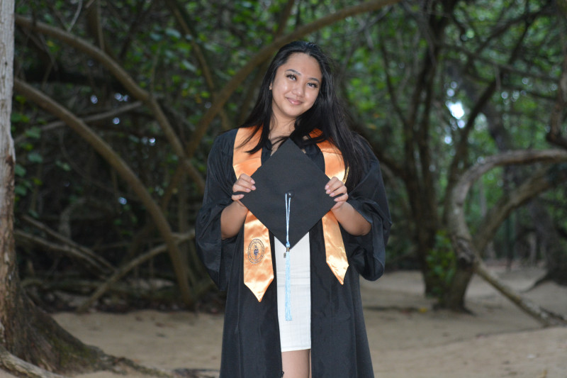Graduate holding cap