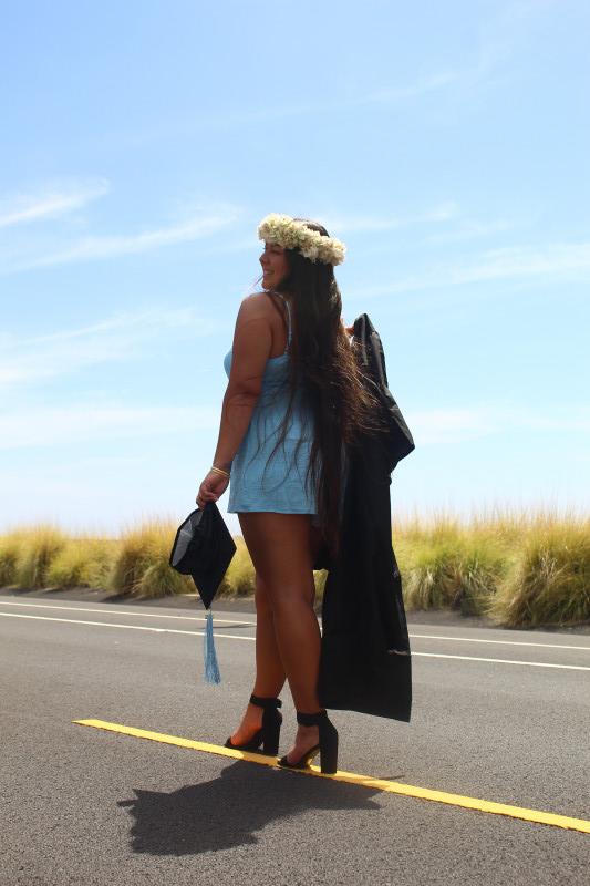 Holding Cap and Gown on Old Tech Road in Kailua-Kona