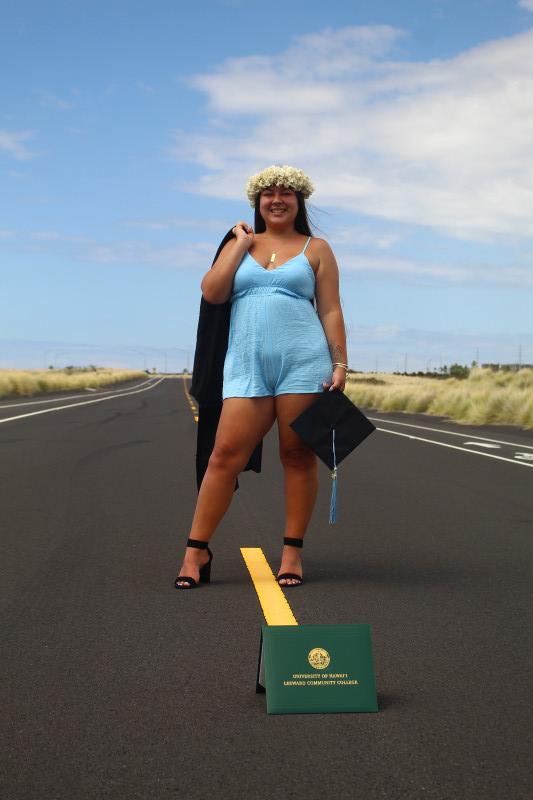 Holding Cap and Gown with Diploma in Picture on Old Tech Road in Kailua-Kona