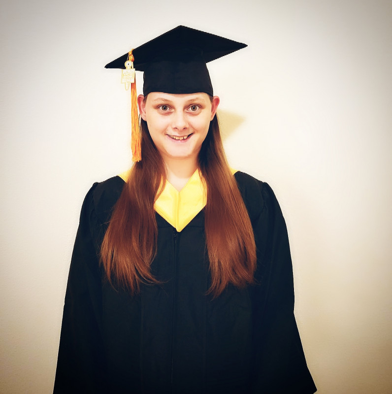 Graduate, Kasandra Comer in graduation attire.