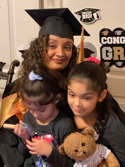 My daughters with me at my graduation at home