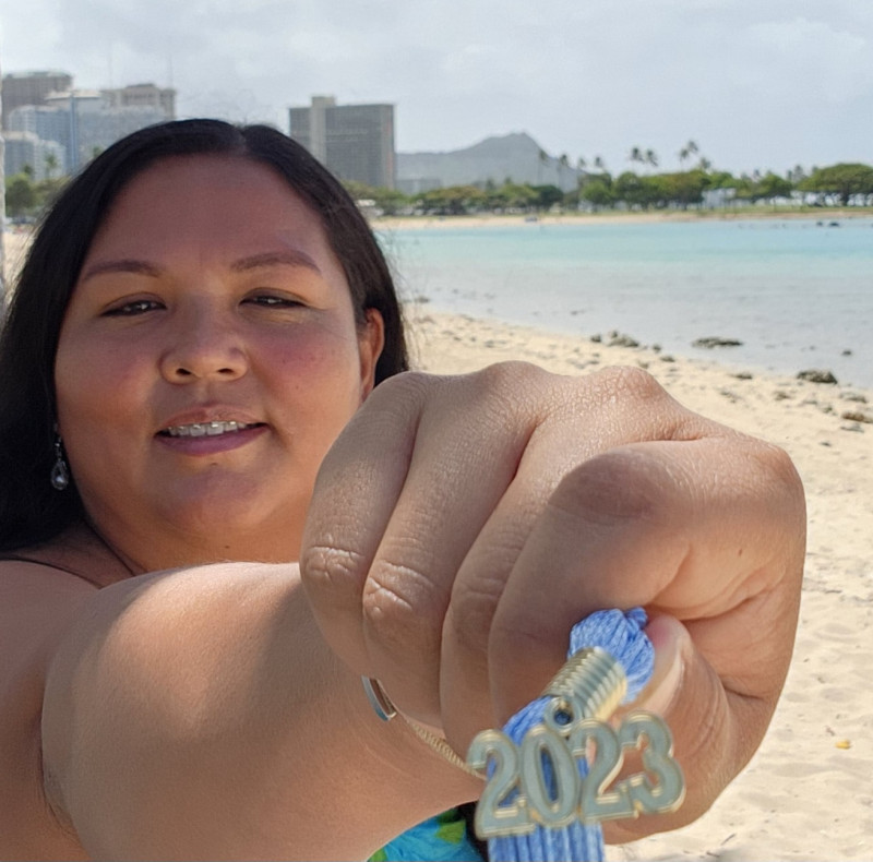 Holding tassel with diamond head behind me