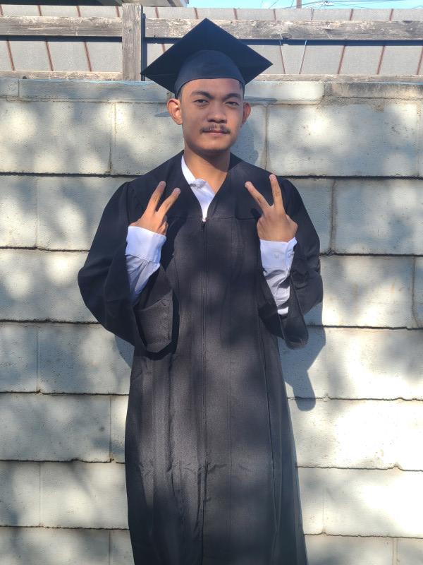 It's a picture of myself in my cap and gown outfit throwing out peace signs.