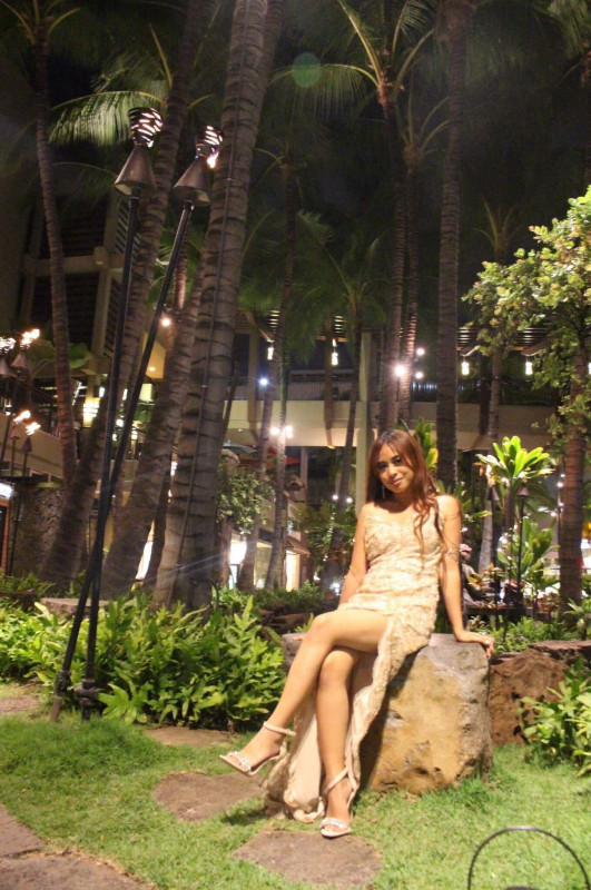 Sitting at the international market in a gold dress