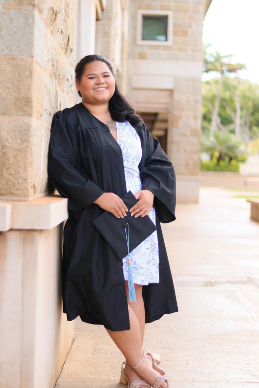 Ashlee smiling with her cap and gown on.