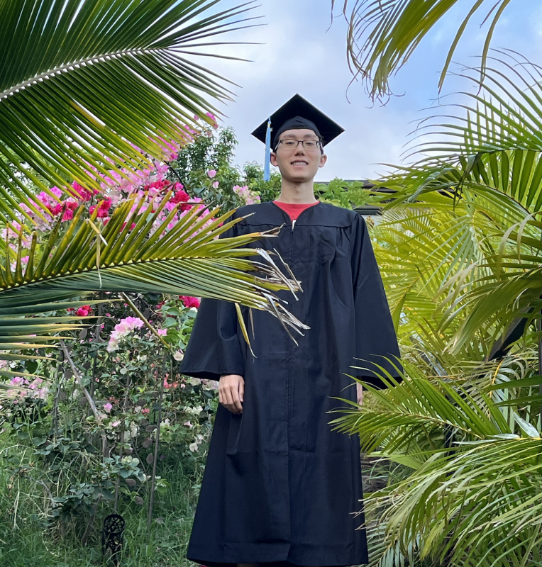 Me in my cap & gown surrounded by nature.