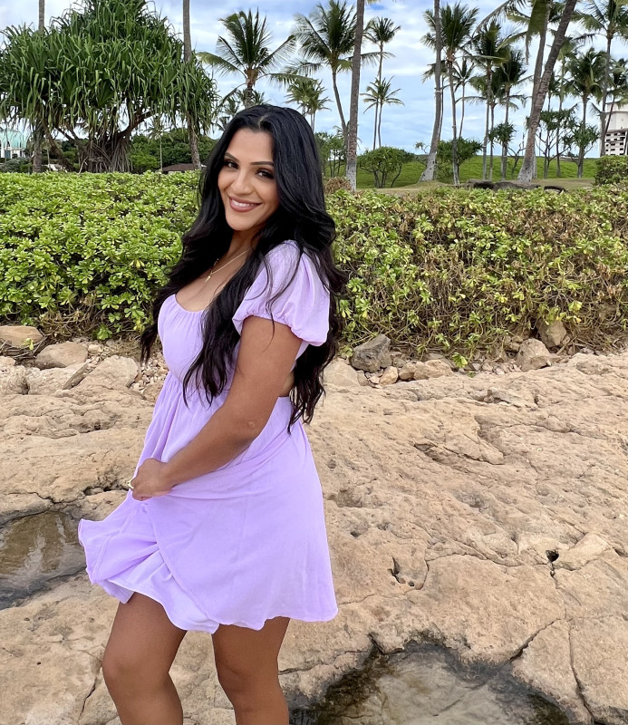 Toni in a lavender dress at the beach