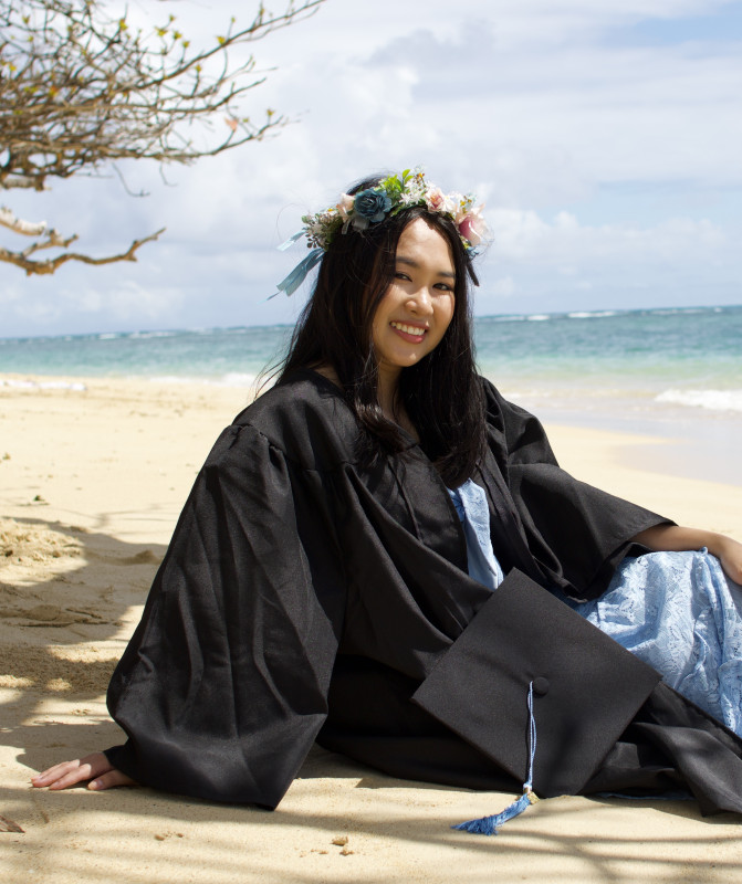 a picture of me at the beach wearing my cap and gown.