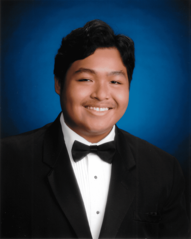 Me (Louis Coloma) in a suit and tie with a blue background.