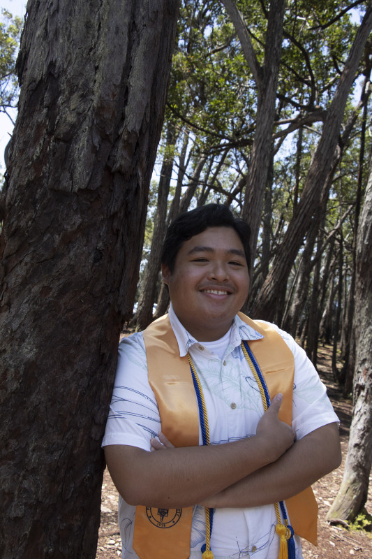 Me (Louis Coloma) wearing a white shirt with accents of blue and green and a gold Phi Theta Kappa stole and a blue and gold Phi Theta Kappa cord.