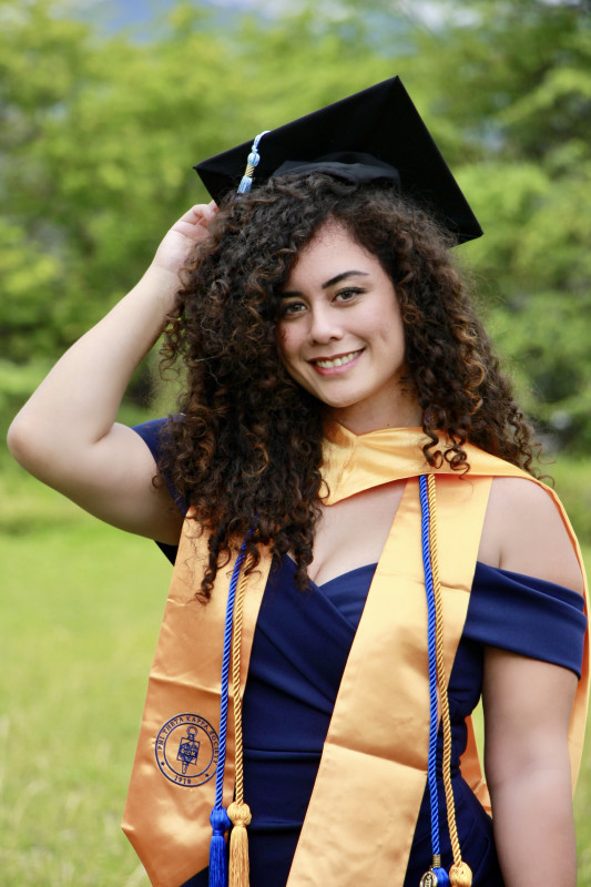 Graduate posing with cap on head