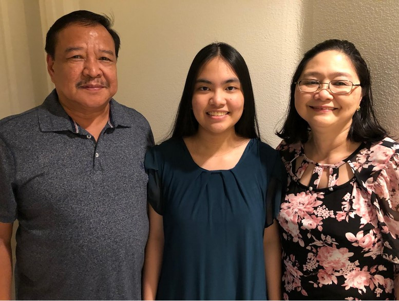 This is a photo of my dad on the left side, then I'm in the center, and my mom on the right side.