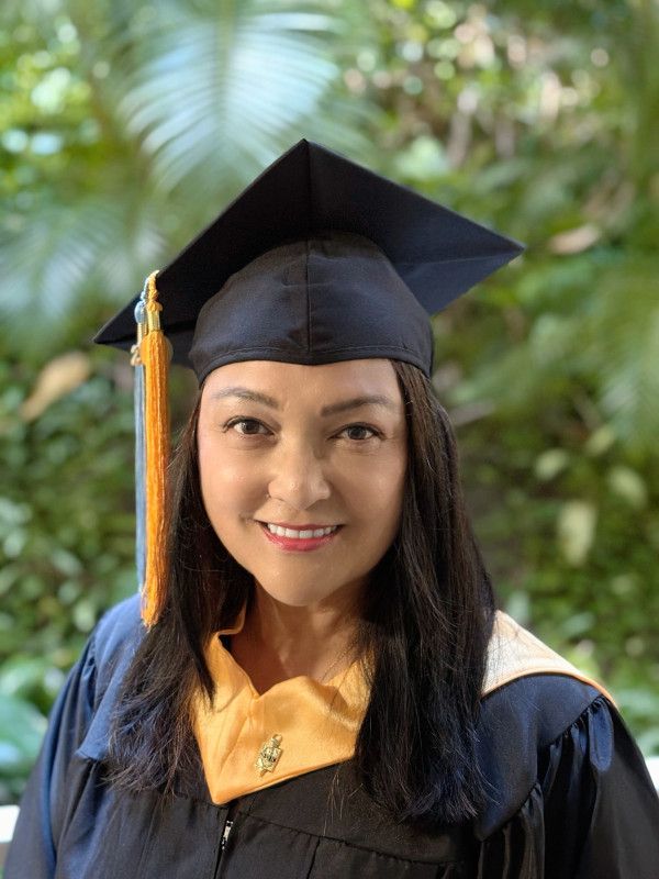It's me! I'm wearing my black graduation cap and gown. And look! I have on my gold honors hood, my PTK gold honors tassel and my LCC blue tassel look so good hanging on my black cap. The black cap & gown makes the regalia pop - it looks so official! I'm smiling so big, so happy!