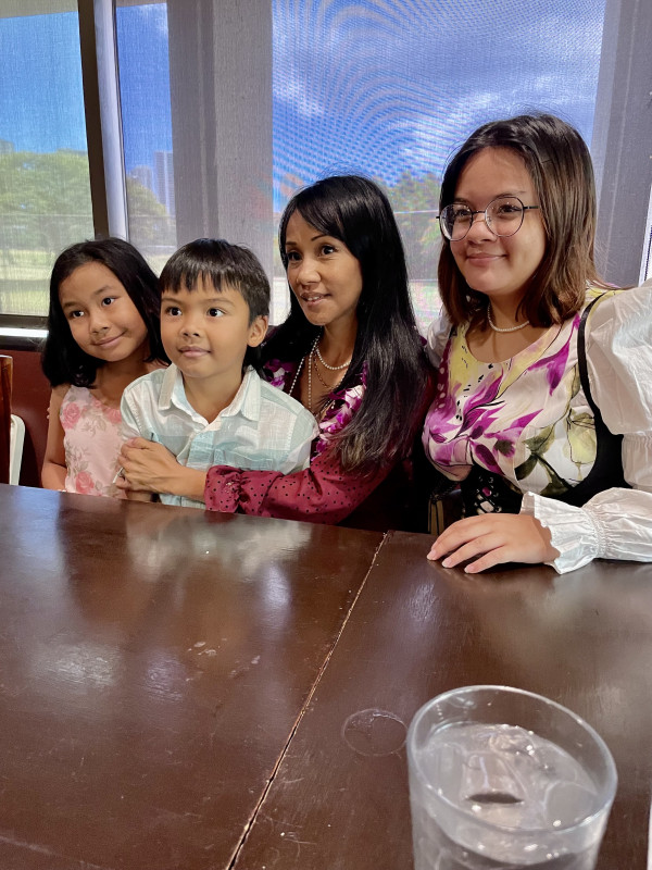 Group photo of Trinity, her mom, and her sister and brother.